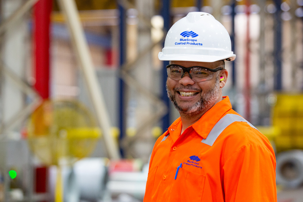man in BlueScope hard hat smiling
